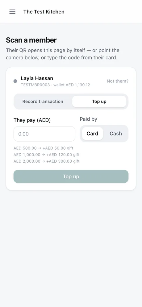 A top-up taken at the counter on a staff phone, cash or card